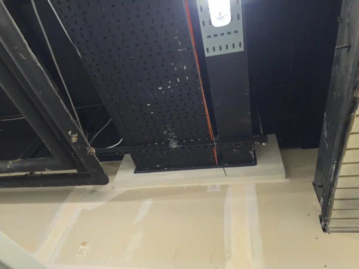 Wide view of fire-stopping installed beneath overhead cable containment